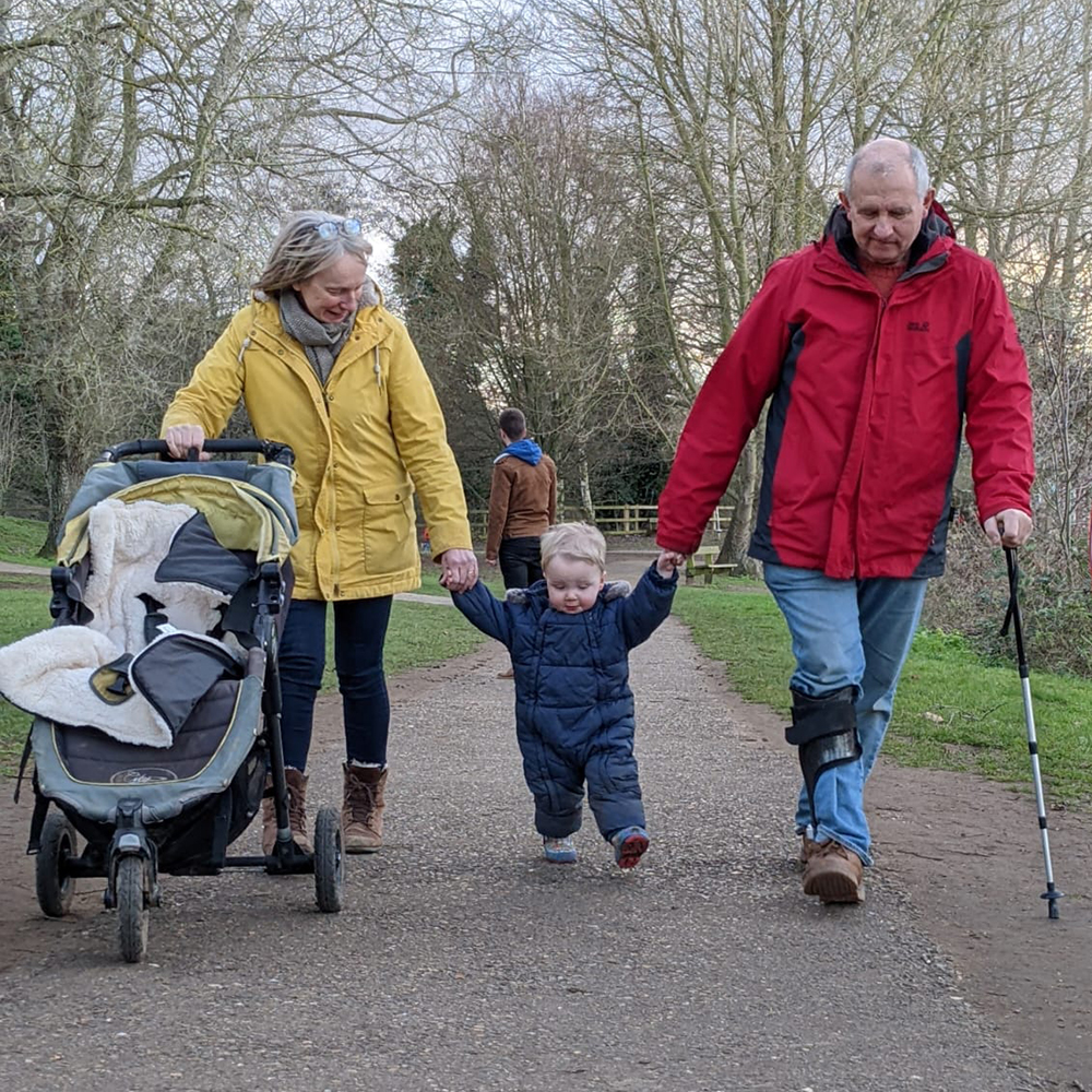 Rob walking with grandchild in his new Neuroswing AFO