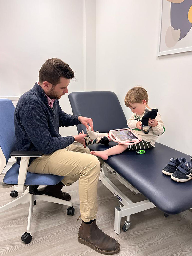 Orthotist Connor Mumford fitting ankle foot orthoses to a young patient with severe hypermobility