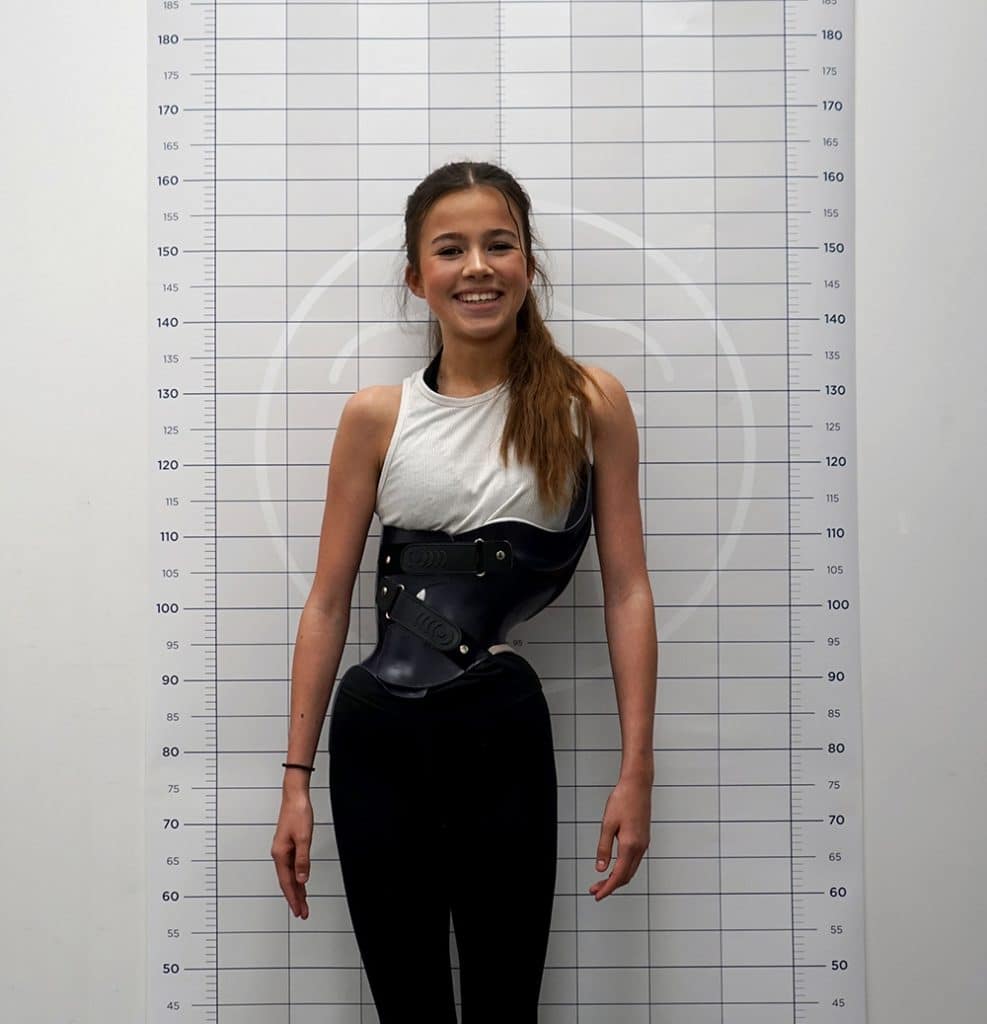Teenage girl and gymnast with scoliosis wearing the London Orthotic Consultancy brace in black